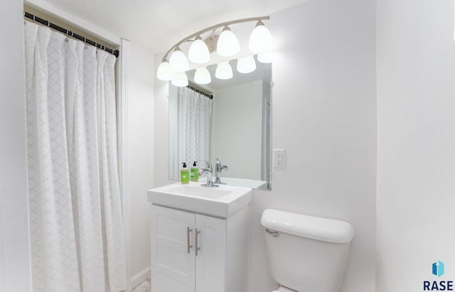 bathroom featuring vanity, curtained shower, and toilet