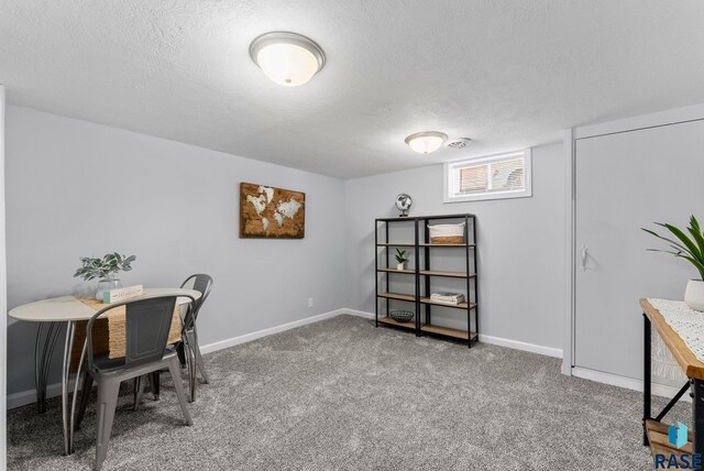 office space featuring baseboards, a textured ceiling, and carpet flooring