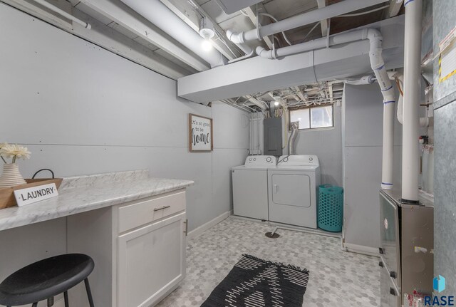 laundry room with electric panel, separate washer and dryer, light floors, and laundry area