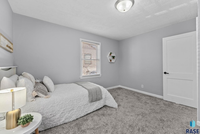 carpeted bedroom featuring baseboards and a textured ceiling