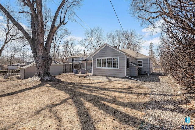 rear view of house with fence