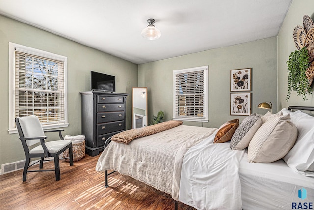 bedroom featuring wood finished floors and baseboards