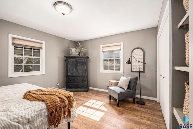 bedroom featuring wood finished floors and baseboards