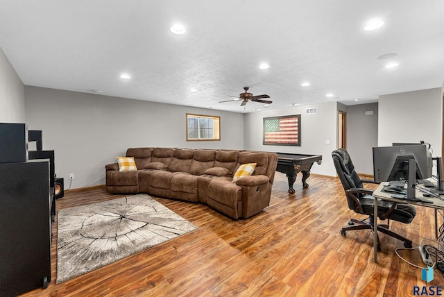 living room with recessed lighting, visible vents, light wood-style flooring, and baseboards