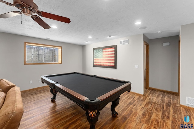 rec room featuring visible vents, a textured ceiling, baseboards, and wood finished floors