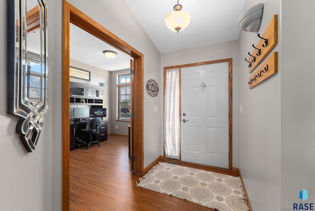 entrance foyer featuring wood finished floors and baseboards