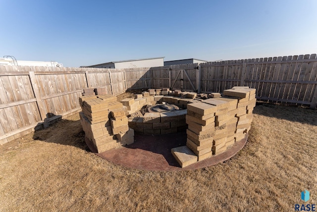 exterior details featuring a fire pit and a fenced backyard