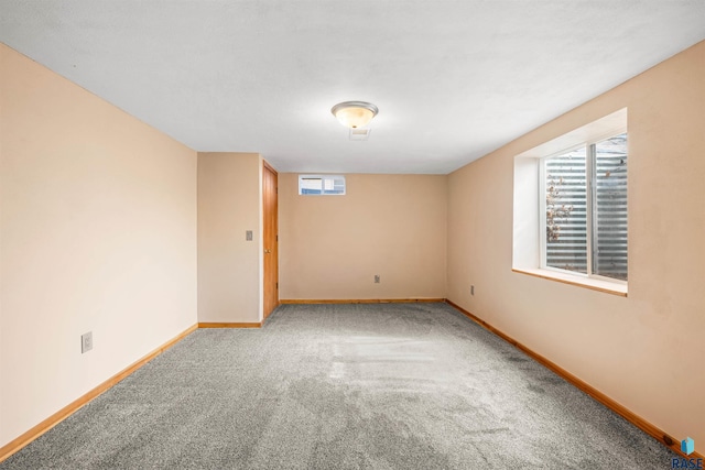 carpeted spare room with baseboards