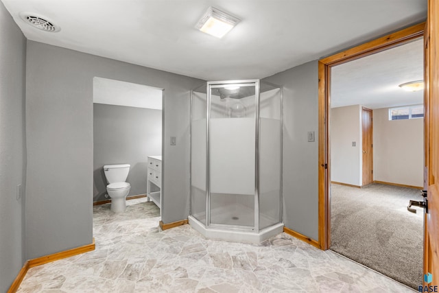 bathroom featuring vanity, baseboards, visible vents, a shower stall, and toilet