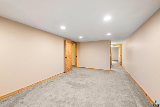 unfurnished room featuring recessed lighting, light colored carpet, and baseboards