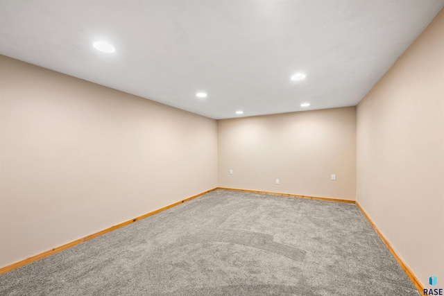 carpeted spare room featuring recessed lighting and baseboards