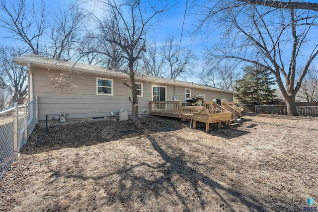 rear view of property with a deck, cooling unit, and a fenced backyard