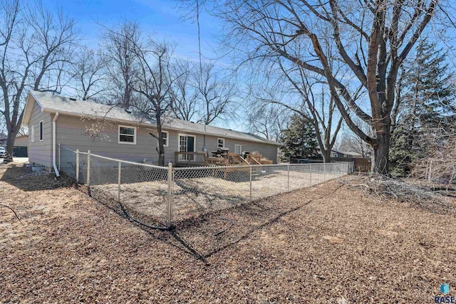 back of house featuring a fenced backyard