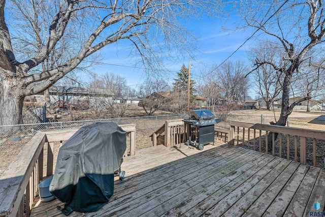 wooden terrace with fence and grilling area