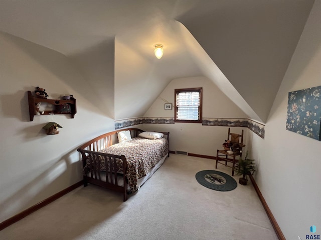 carpeted bedroom with visible vents, baseboards, and vaulted ceiling