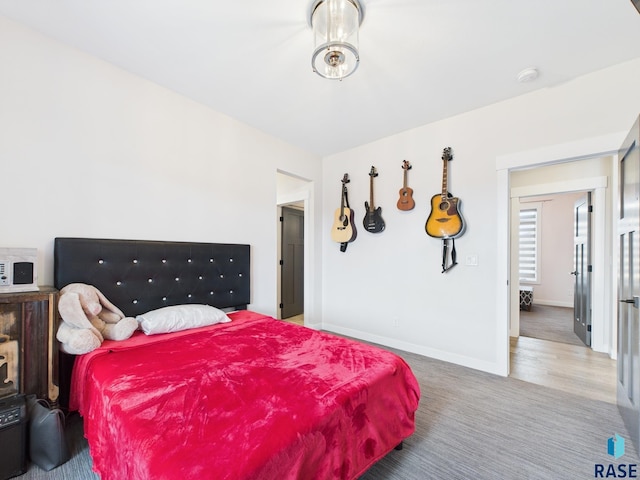 bedroom with carpet flooring and baseboards