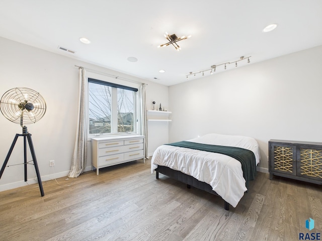 bedroom featuring recessed lighting, visible vents, baseboards, and wood finished floors