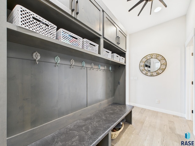 mudroom with light wood finished floors, a ceiling fan, and baseboards