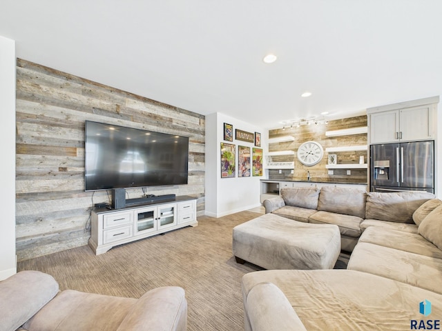 living room with recessed lighting, baseboards, light colored carpet, and wooden walls