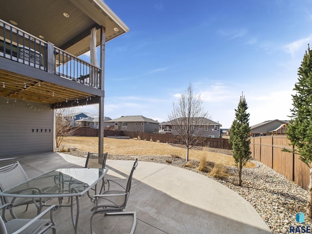 view of patio / terrace with a residential view, outdoor dining area, and a fenced backyard