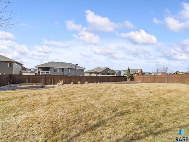 view of yard featuring a residential view and fence