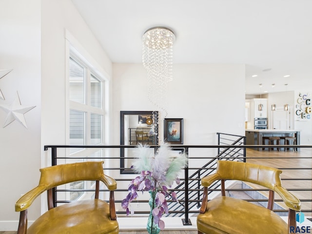 sitting room featuring a notable chandelier, an upstairs landing, recessed lighting, and baseboards