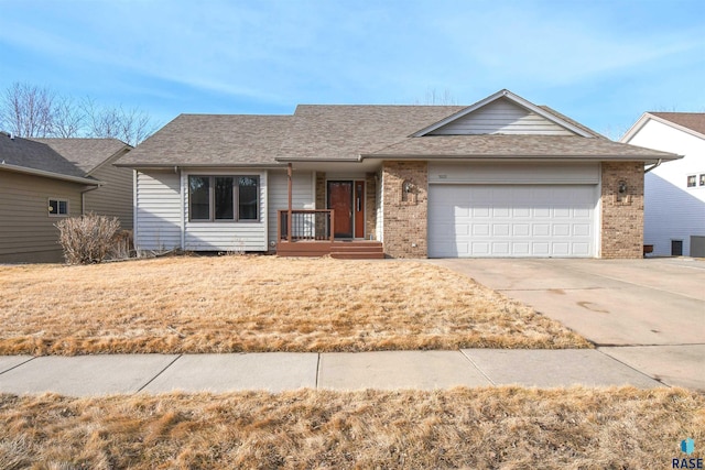 ranch-style house with brick siding, roof with shingles, concrete driveway, and an attached garage