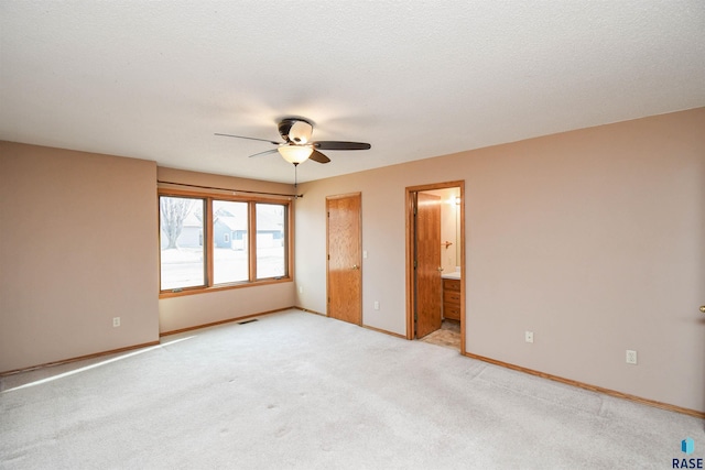 unfurnished bedroom featuring visible vents, baseboards, light colored carpet, and a textured ceiling