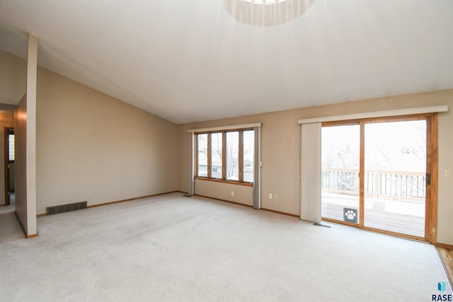 unfurnished living room featuring visible vents, baseboards, light colored carpet, and vaulted ceiling