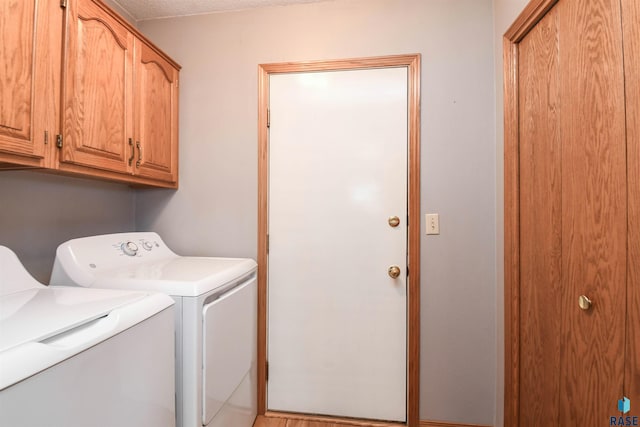 laundry area with cabinet space and washing machine and dryer