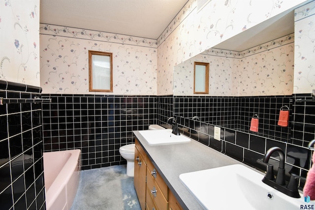 full bathroom featuring a wainscoted wall and wallpapered walls