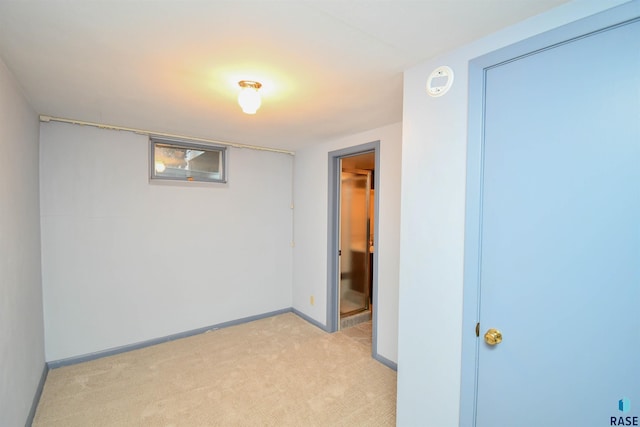 unfurnished bedroom featuring a closet, light colored carpet, and baseboards