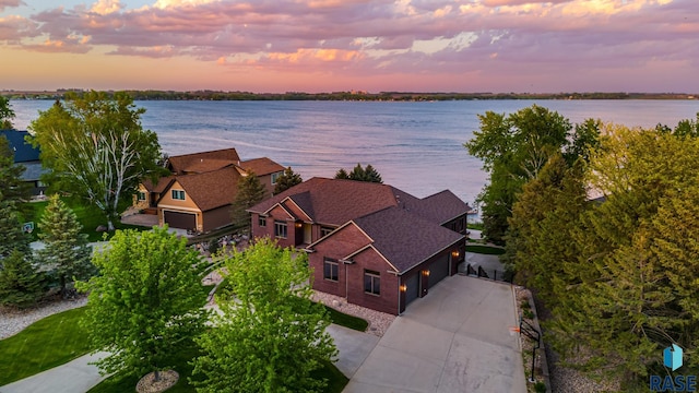 aerial view at dusk with a water view