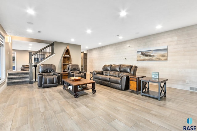 living area featuring stairs, recessed lighting, light wood-style floors, and visible vents