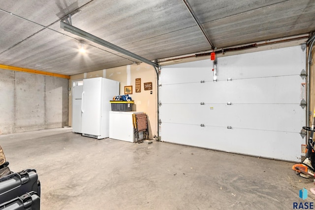 garage with fridge and freestanding refrigerator