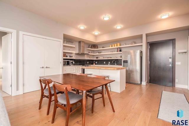 dining space featuring light wood-style flooring