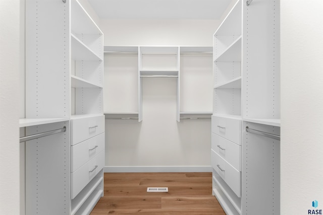 spacious closet featuring light wood finished floors and visible vents