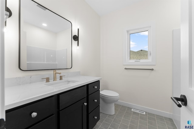 bathroom featuring vanity, visible vents, baseboards, tile patterned floors, and toilet