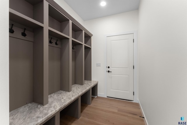 mudroom with recessed lighting, baseboards, and light wood-type flooring