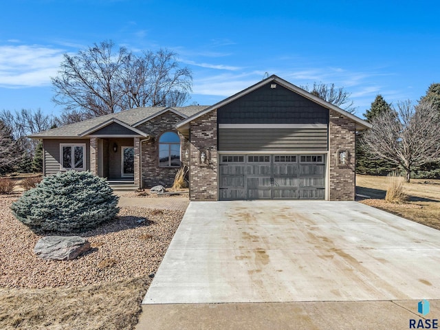 view of front of home with concrete driveway, an attached garage, and brick siding