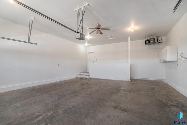 garage featuring a garage door opener and baseboards