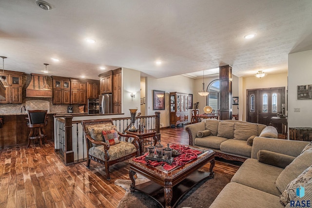 living area with recessed lighting and dark wood-style flooring