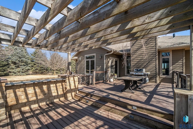 wooden deck with area for grilling and a pergola