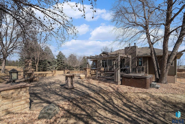 view of yard with a deck and a hot tub