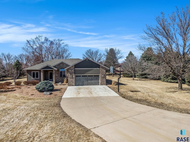 view of front of property with brick siding, driveway, and an attached garage