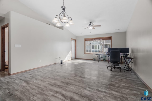 office area with visible vents, ceiling fan with notable chandelier, wood finished floors, baseboards, and vaulted ceiling