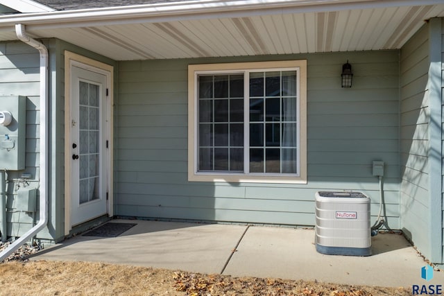 property entrance featuring covered porch and central AC