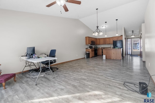 home office featuring high vaulted ceiling, ceiling fan with notable chandelier, light wood-type flooring, and baseboards