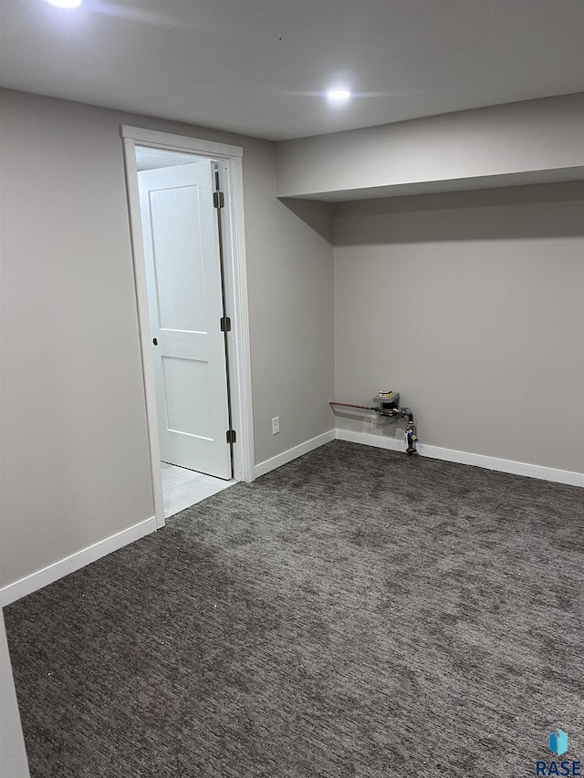 finished basement featuring baseboards and carpet flooring