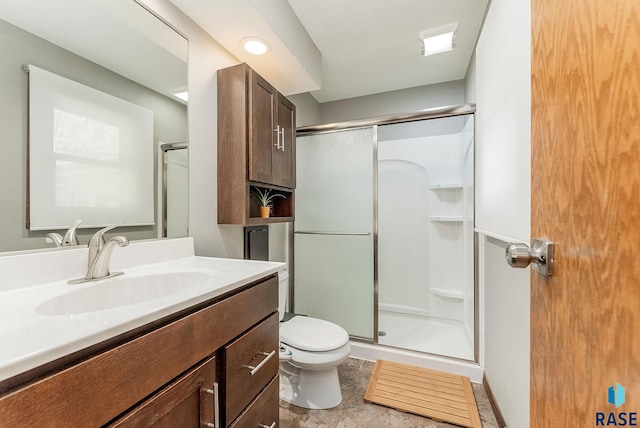 full bathroom featuring vanity, toilet, and a shower stall